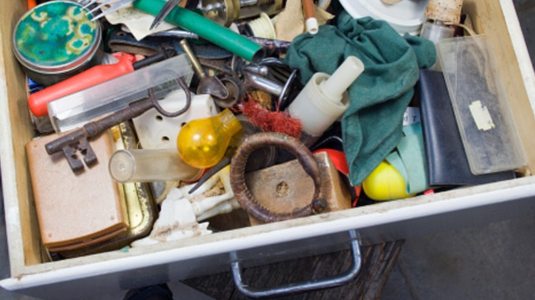 Overfilled junk drawer with miscellaneous items