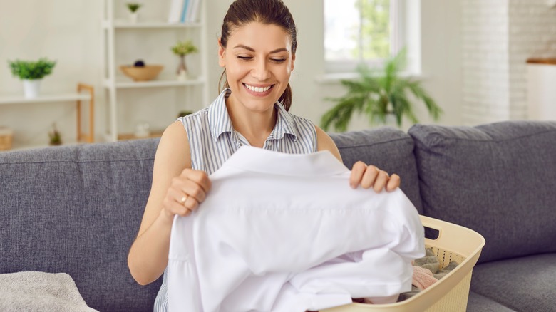 woman smiling at wrinkle-free shirt