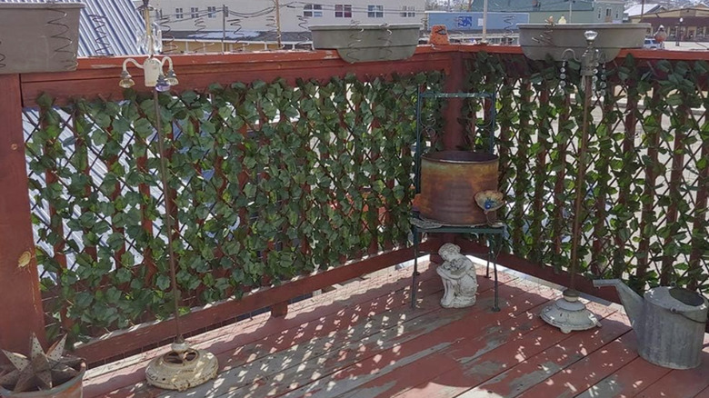 Privacy screen attached to the front of a fenced balcony