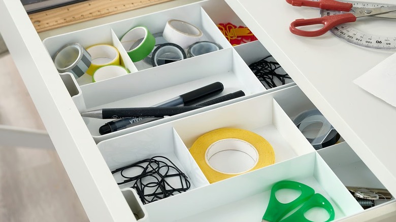 IKEA KUGGIS insert being used to organize office supplies in a drawer