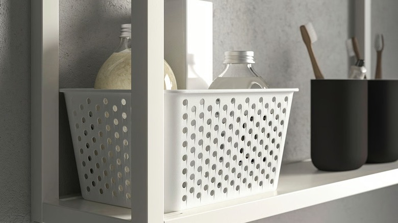 IKEA PLOGSVÄNG basket holding two bottles on a shelf