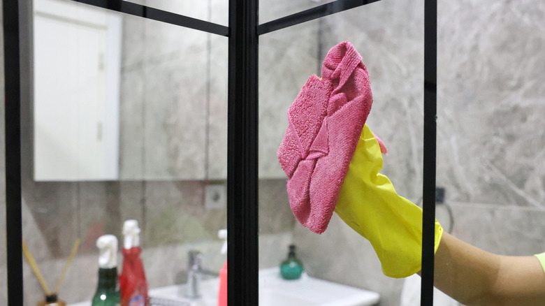 wiping shower doors with cloth