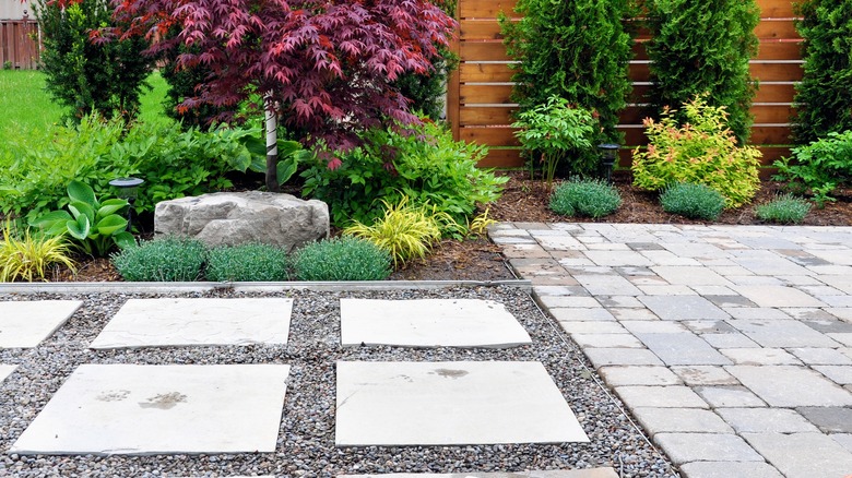 yard with stone patio and walkway