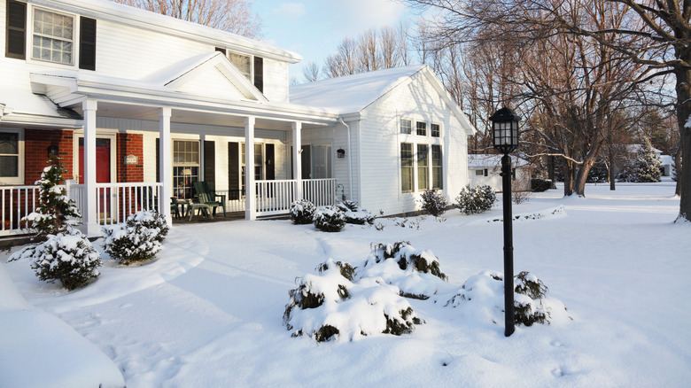 Home with a snowy driveway