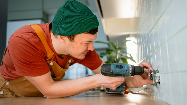 Man installing a new kitchen outlet