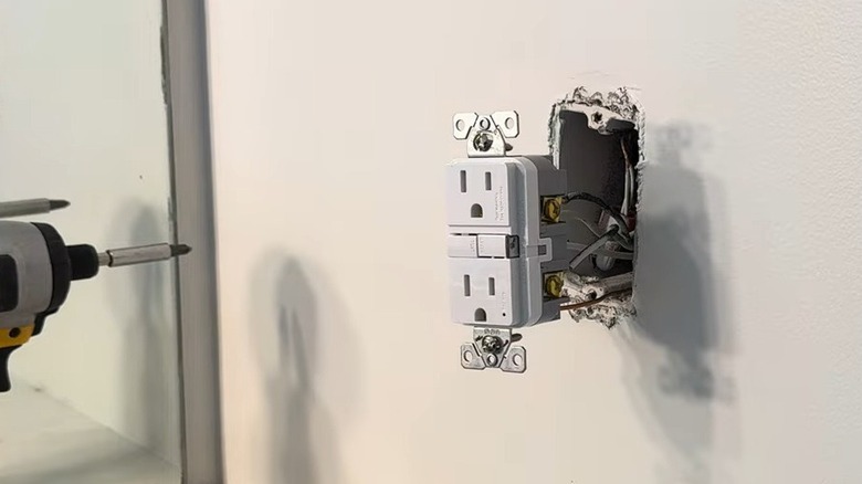 Close-up of a GFCI outlet being installed