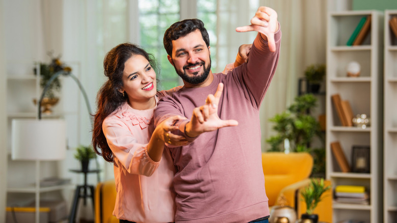 young couple evaluating room for interior design