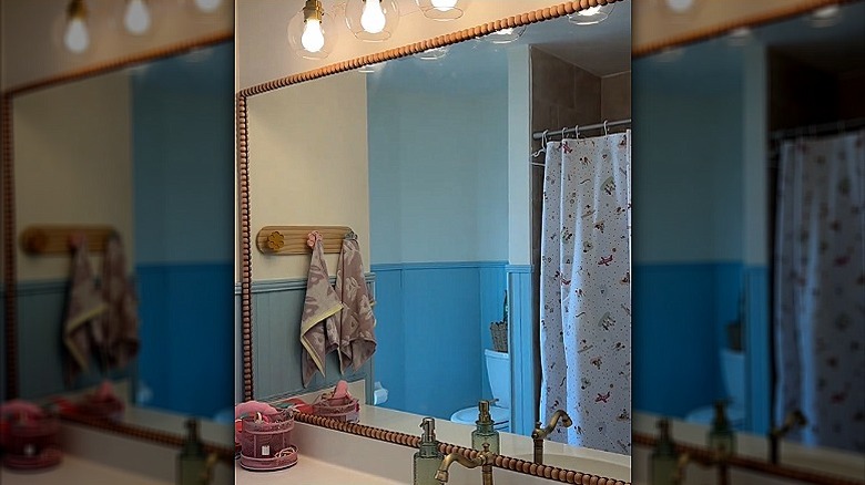 A bathroom mirror trimmed with temporary moulding