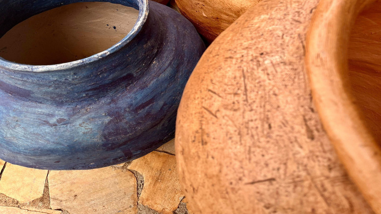 A variety of ceramic vases with raw clay texture on the outside.