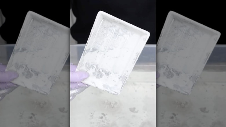 Person hydro-dipping a soap holder