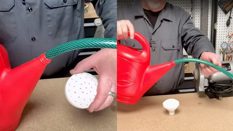 Red watering can with green hose inserted into spout