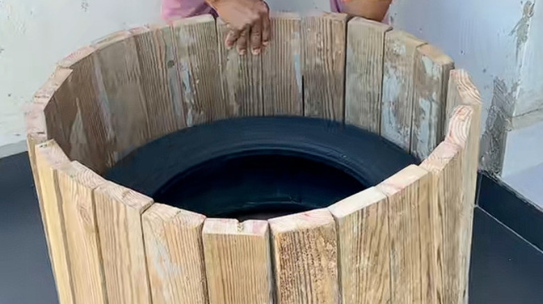 A tire with narrow boards drilled around the outer edge
