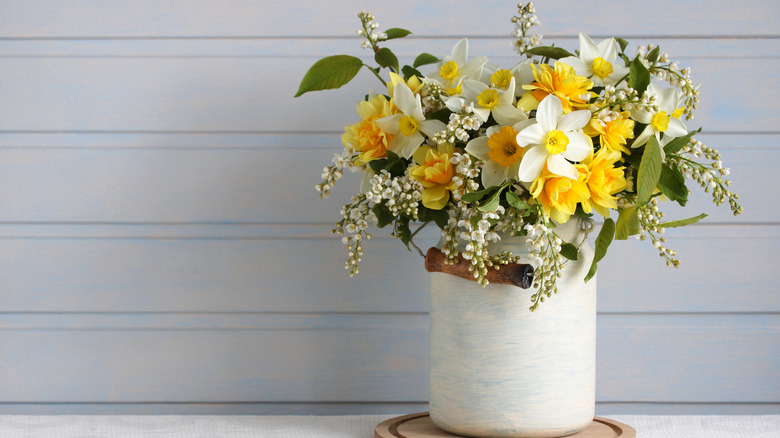 An arrangement of flowers in a can vase
