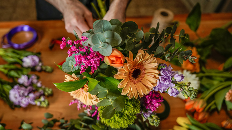 A pair of hands working with flowers