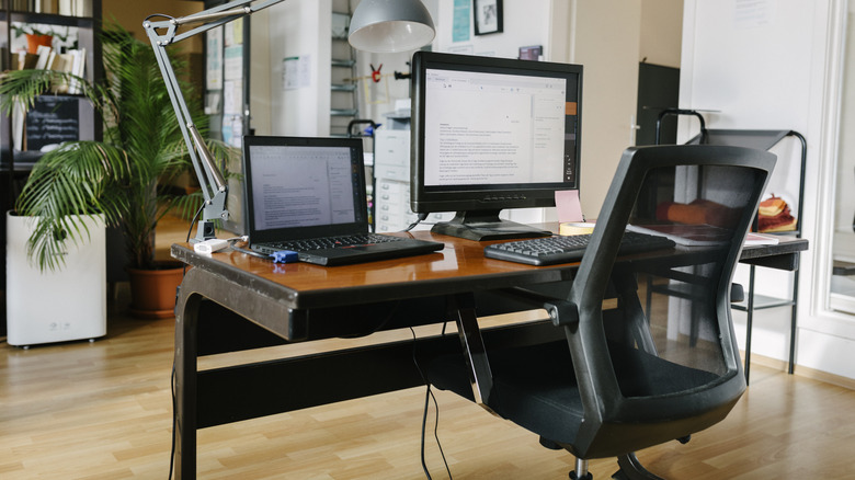 A black mesh chair behind a desk