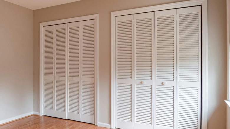 A wall of white louvered closet doors.
