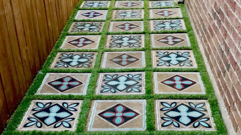 A walkway with stepping stones painted to look like repeated tiles