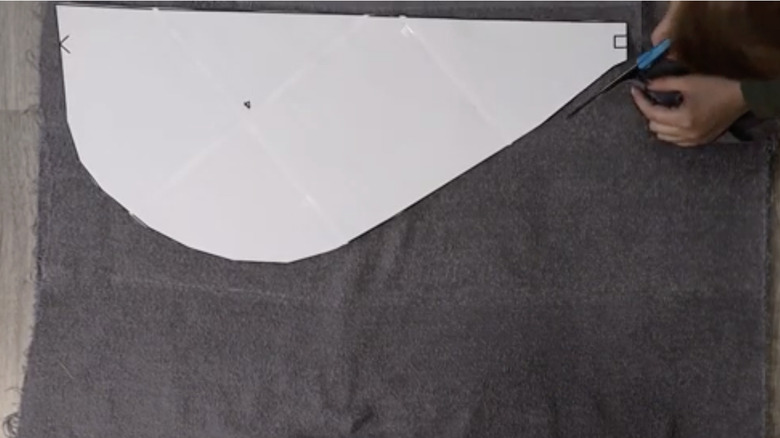 Woman cutting bath towel into a hair wrap.