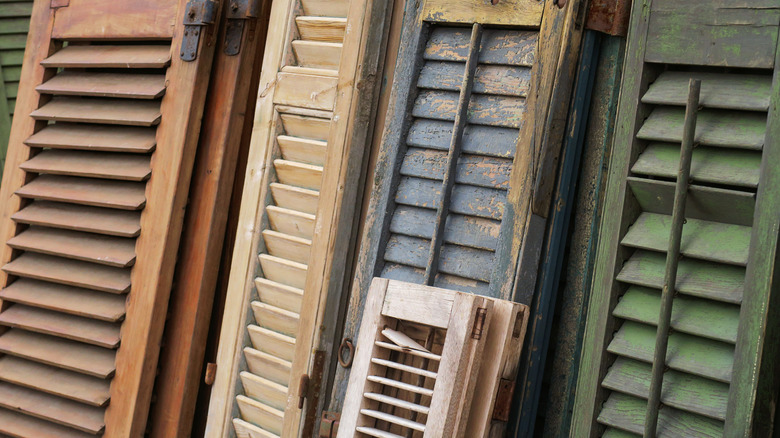 A collection of vintage wood window shutters.
