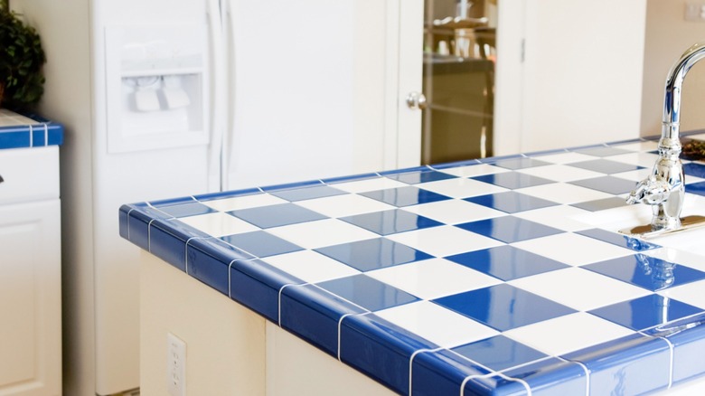 Blue and white tiled kitchen countertop with sink