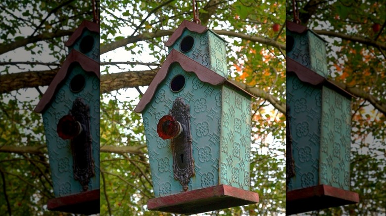 A vintage-style bird feeder decorated with an antique door knob