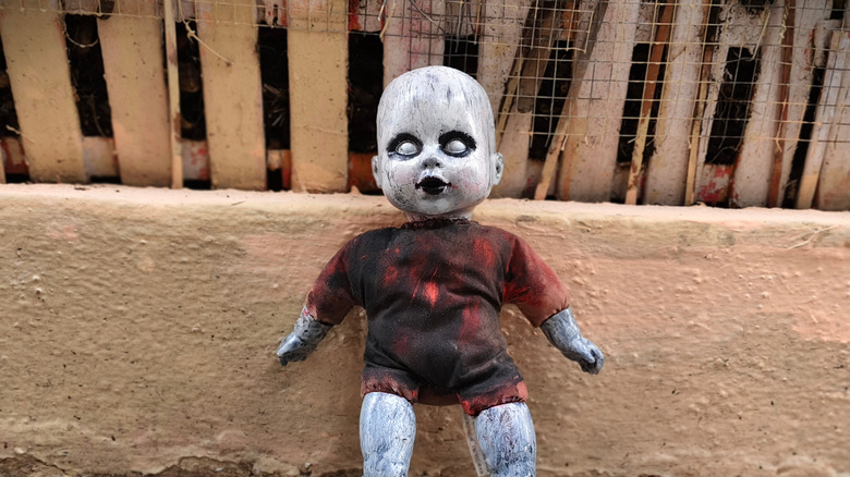 Creepy, aged doll for Halloween with white face