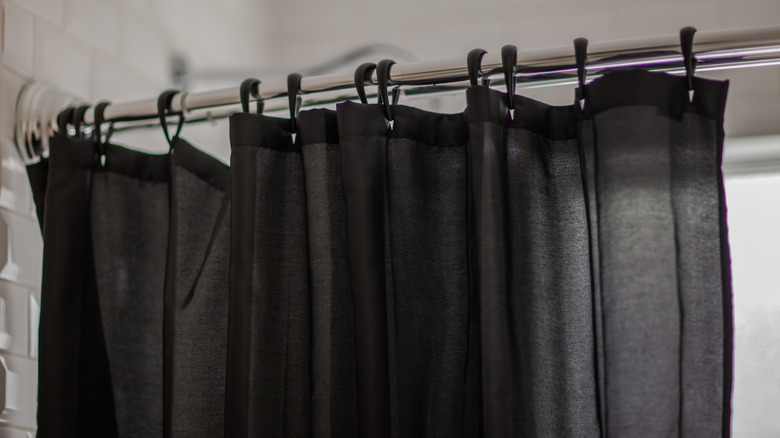 A closeup of a black, cotton shower curtain