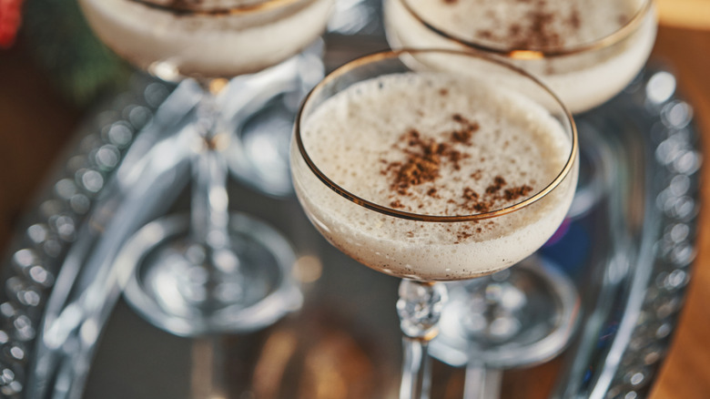 eggnog in fancy glasses on a silver tray