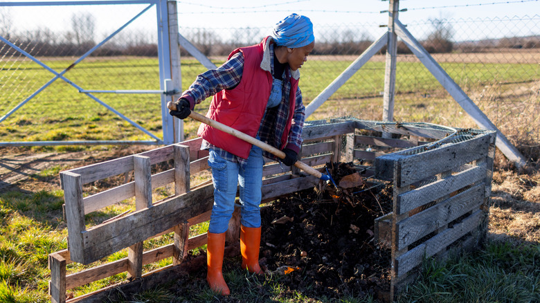 Turning compost heap with fork