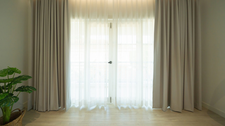 Pleated beige curtains in a living space
