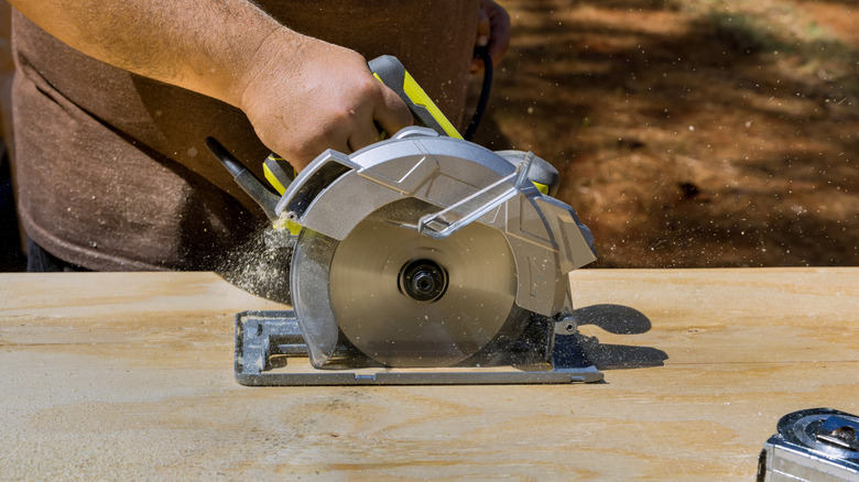 Cutting through a sheet of plywood with a circular saw