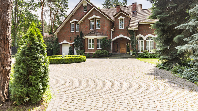 A modern home with a gravel driveway