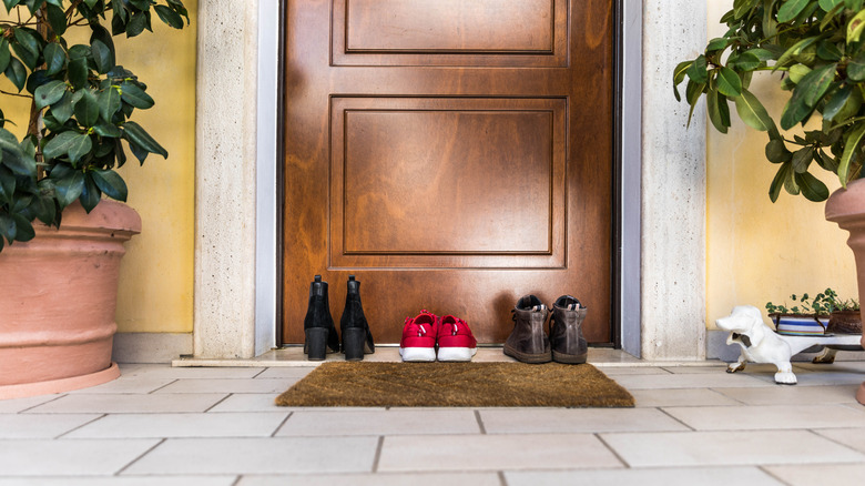 An entryway mat and shoes