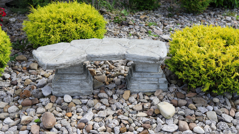 A stone garden bench in rocks