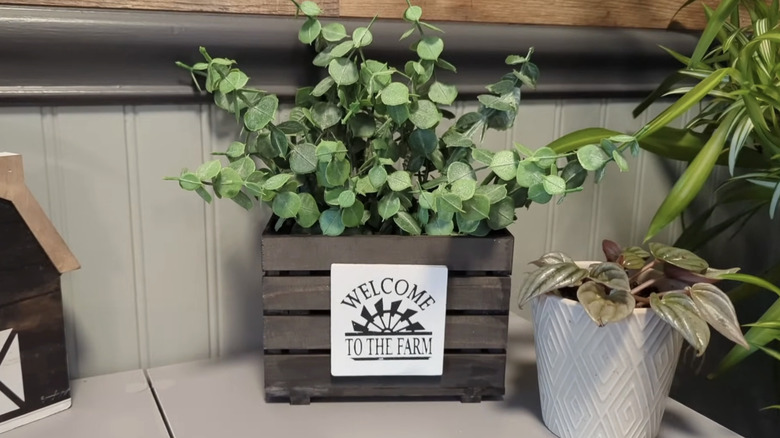 Rustic farmhouse crate decor with greenery.