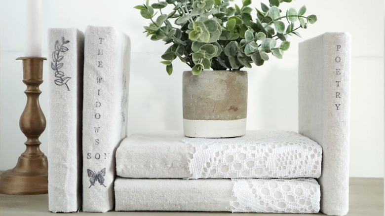 A set of books with linen covers and lace.
