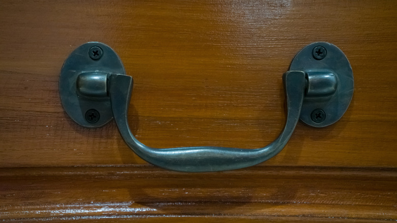 Metal drop pull on wood drawer