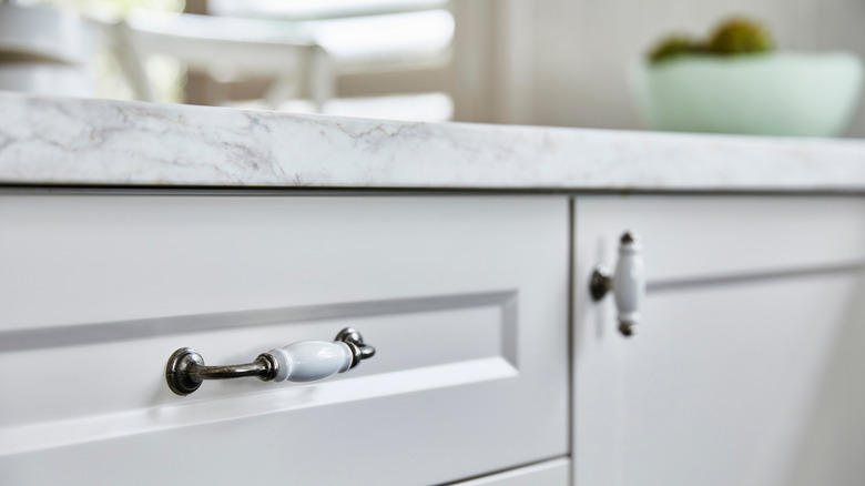 Porcelain drawer pulls on white cabinetry