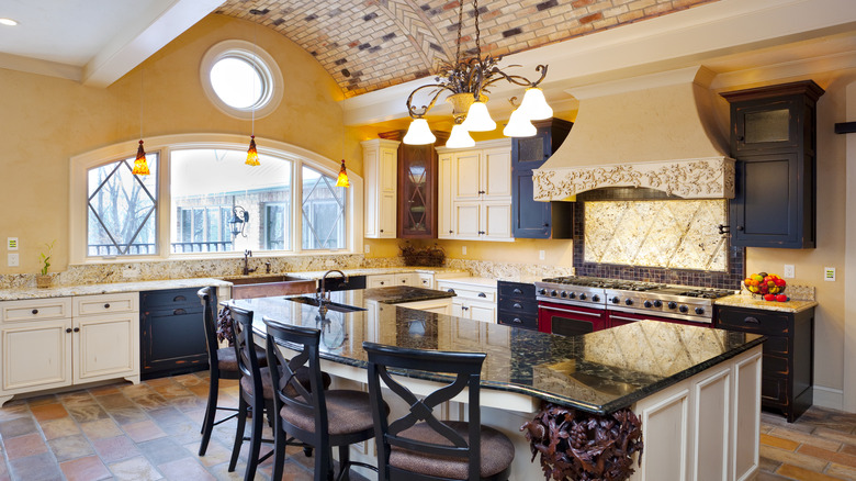 A modern kitchen has a brick-like floor