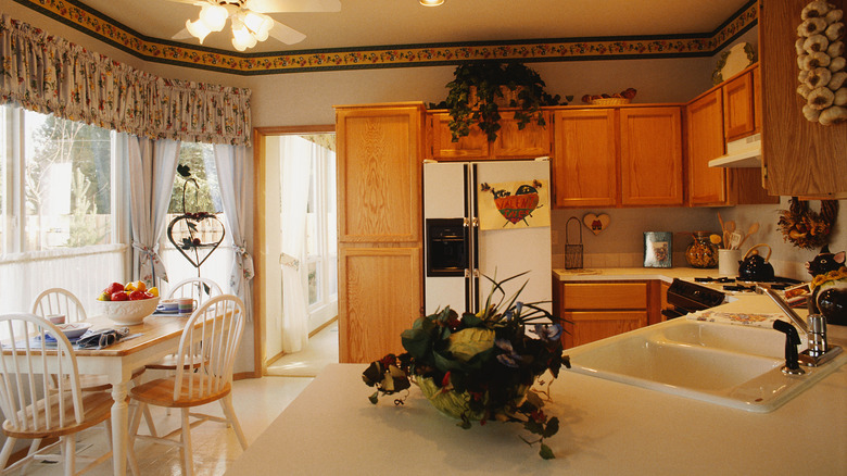 A 1990s-style kitchen with honey oak cabinets