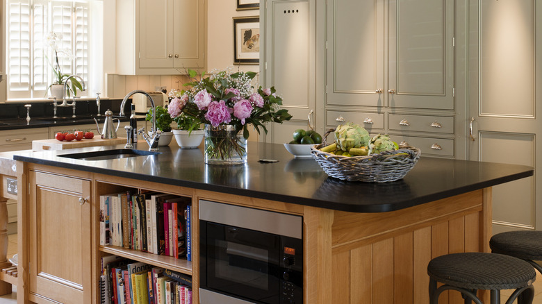 Open shelving in kitchen island filled with books