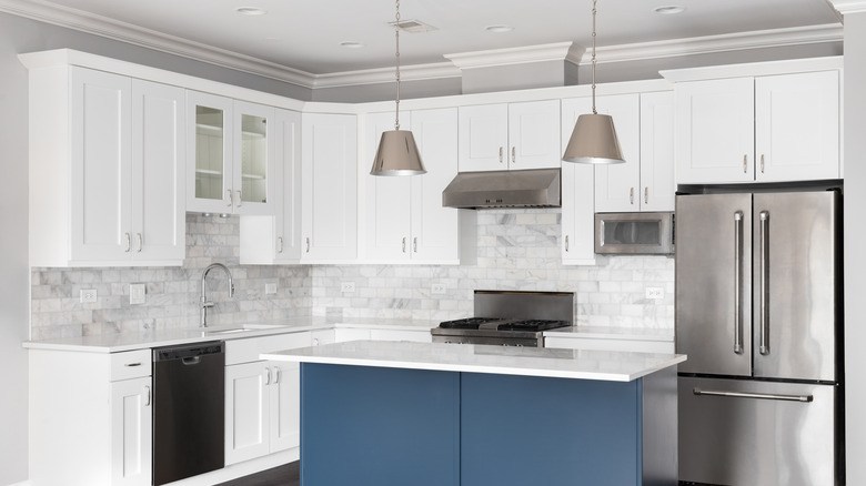 Kitchen with white cabinets and open space above