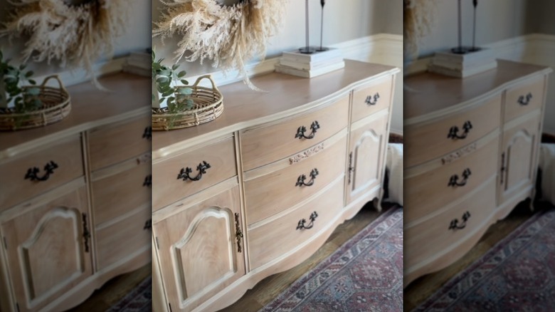A refurbished vintage or antique wooden credenza in a living room.