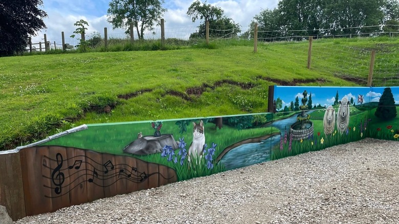woman painting a retaining wall