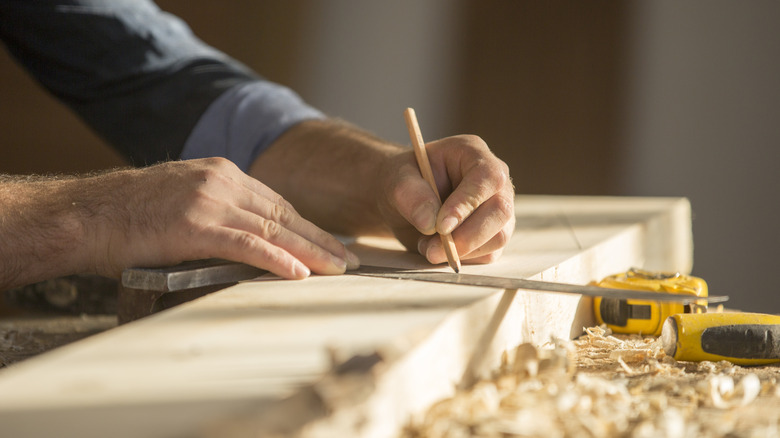 A man works on a woodworking project