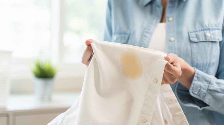 Close up of woman holding stained laundry