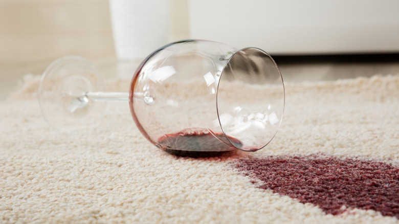 Close up of red wine spilled on white carpet