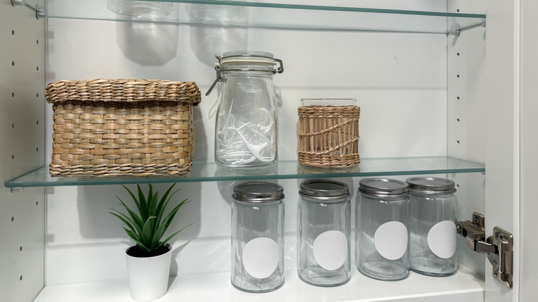 Clear glass jars in medicine cabinet