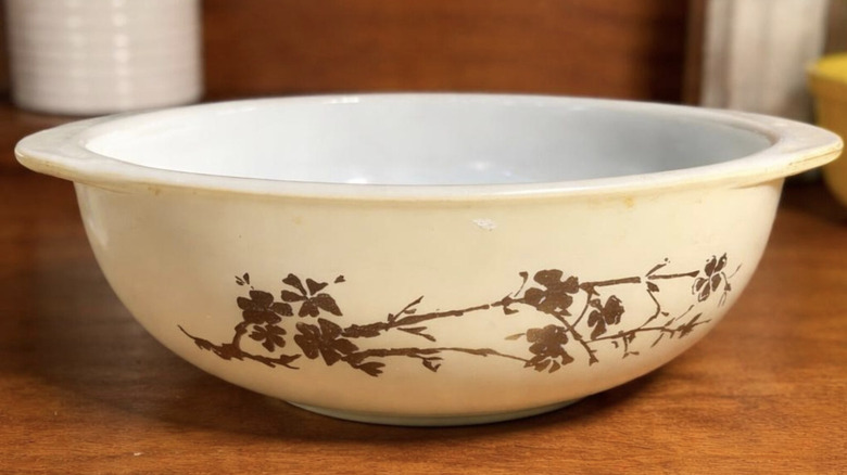 Vintage Pyrex Golden Branch casserole dish without lid sitting on a counter