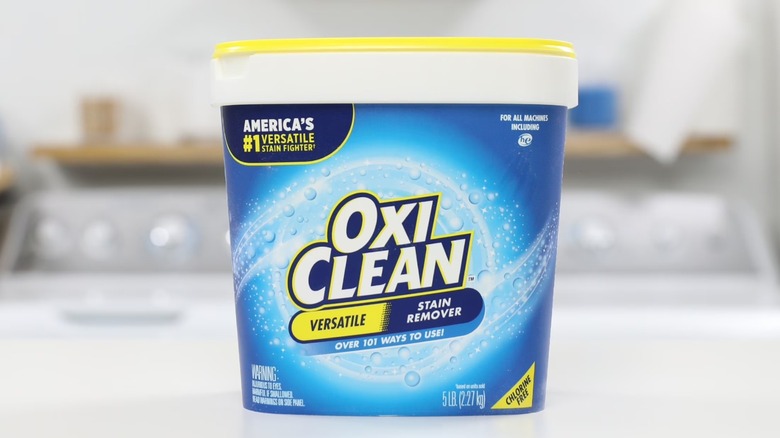 Oxyclean Stain Remover Powder container on a laundry room counter